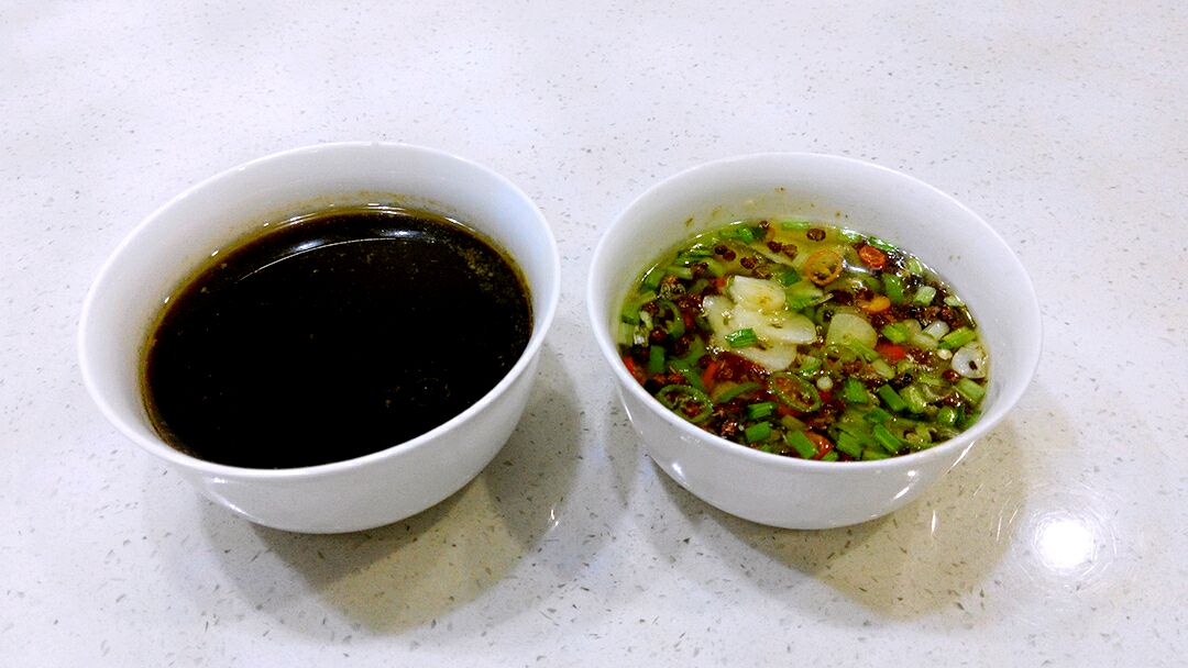 右面的碗里是青红椒葱蒜和花椒,用热油淋过.